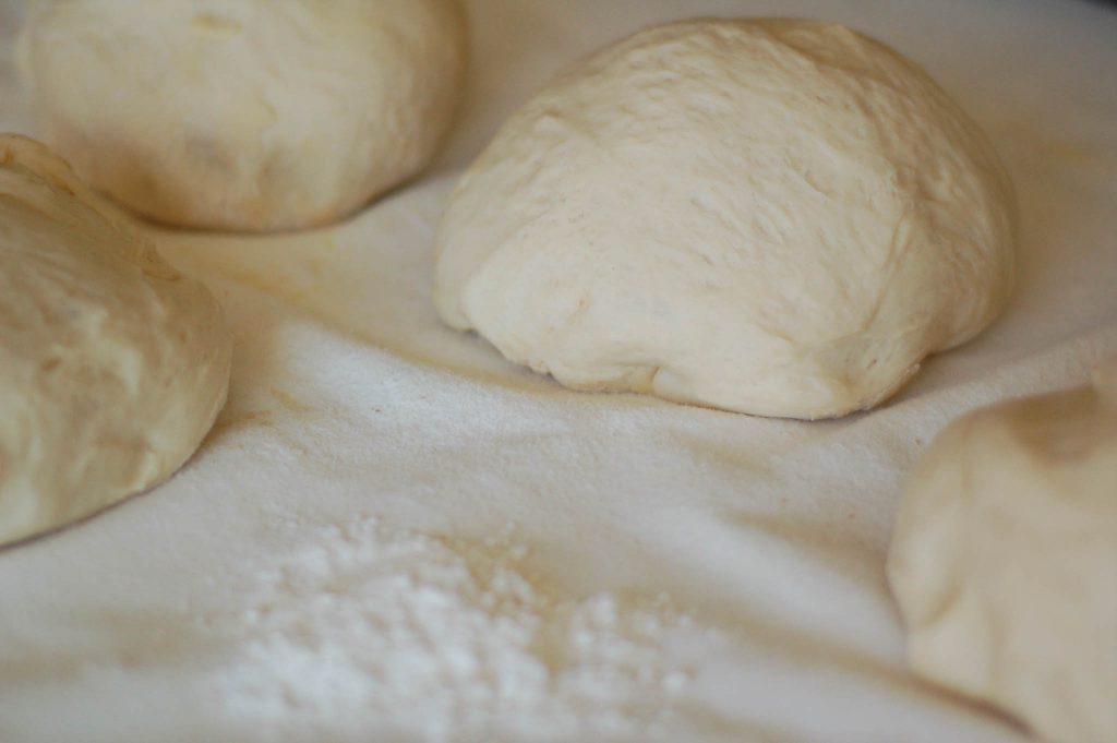 four divided pieces of bread dough