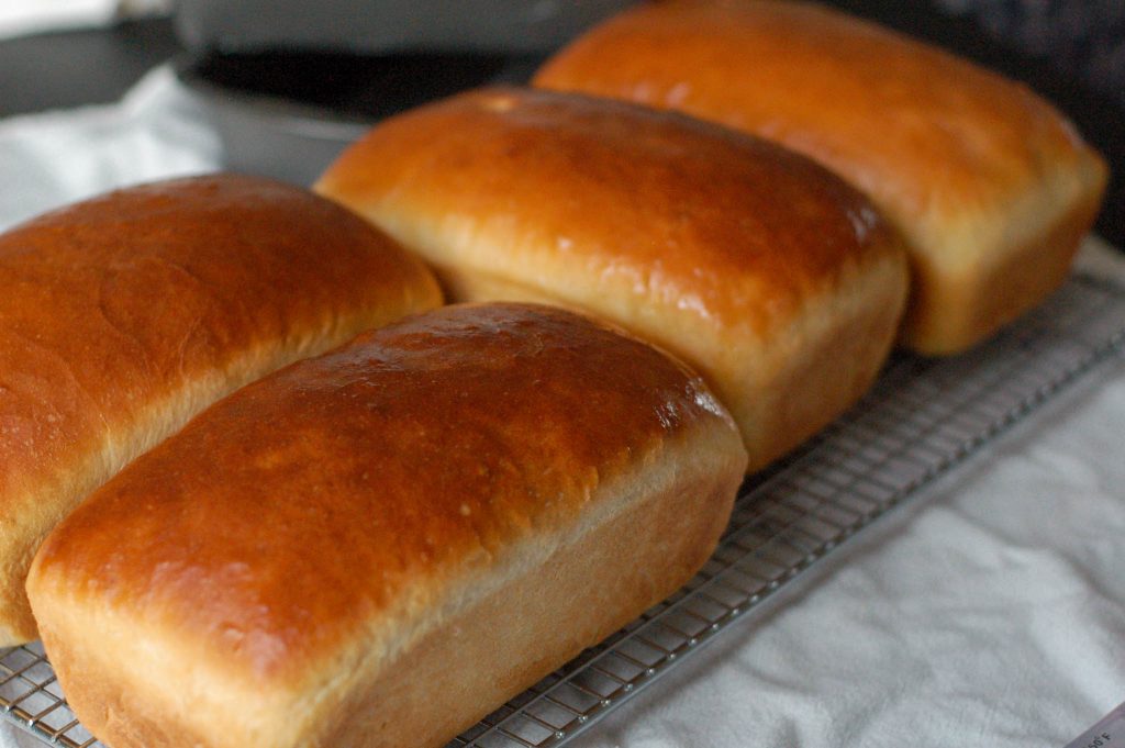 four loaves of golden homemade bread