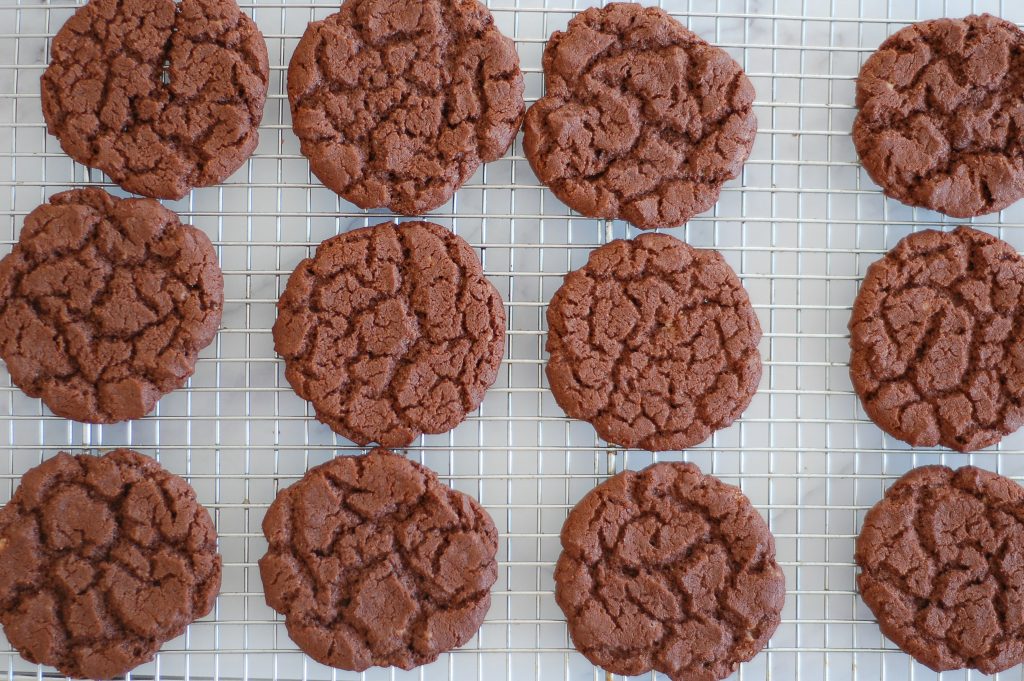 12 homemade chocolate cookies on a cooling rack