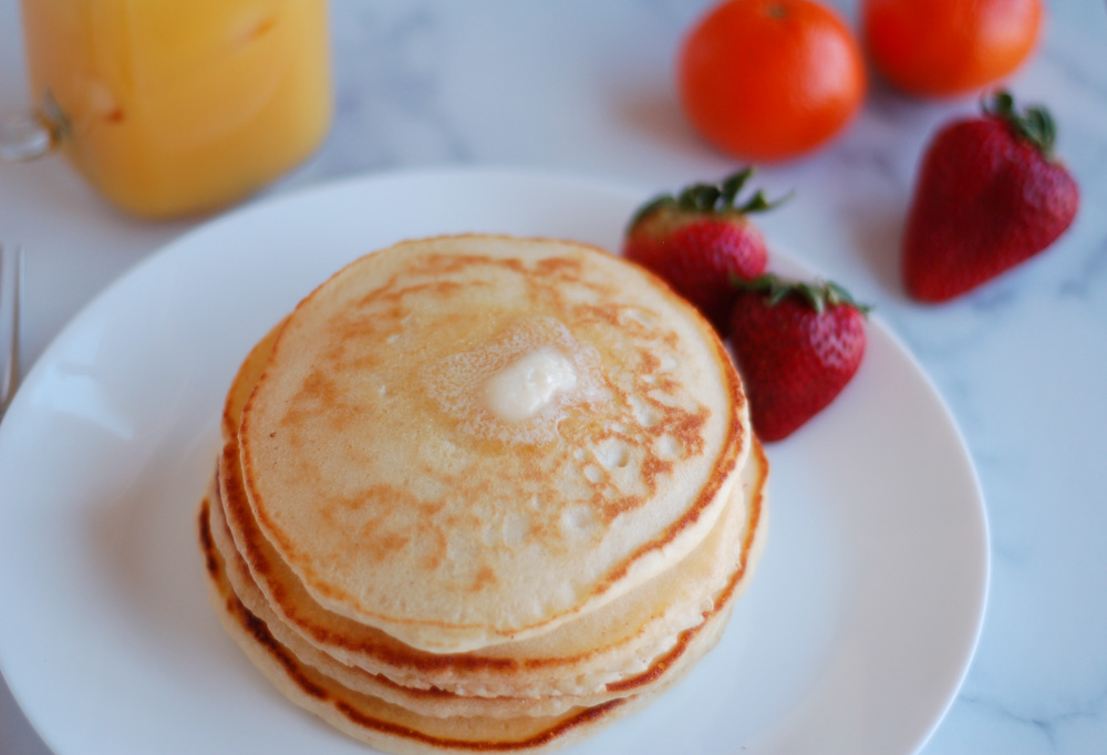 fluffy homemade pancakes with fresh fruit and melting butter