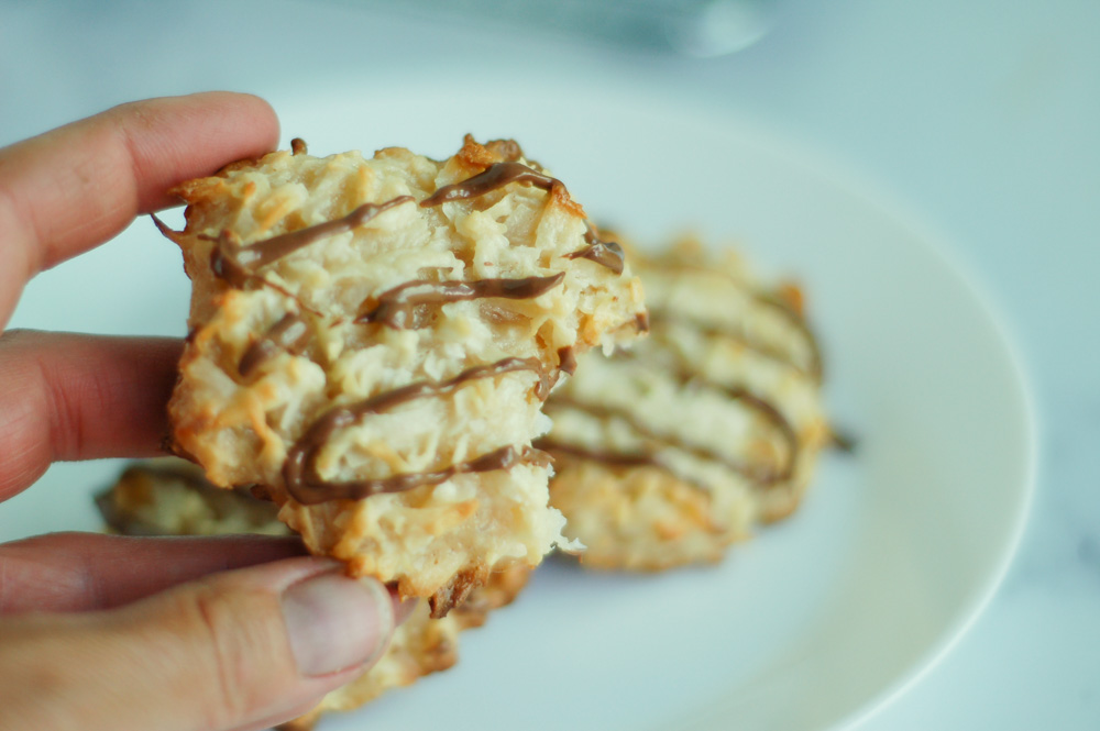 hand holding a chocolate covered coconut macaroon